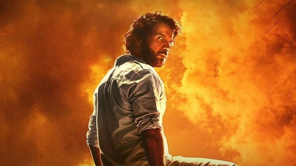A man stands against a backdrop of flames in the film "Maalik".