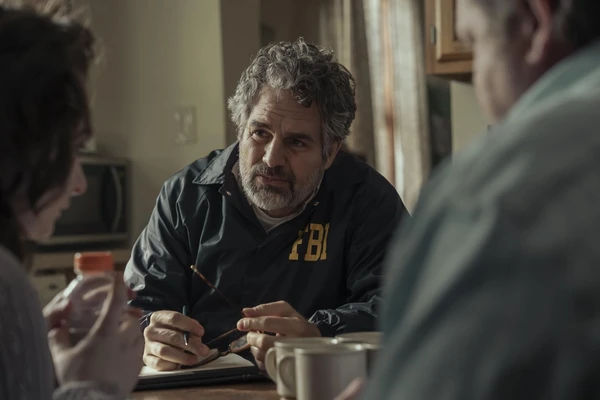 An FBI agent interviews people, focused and intent, in "Task".