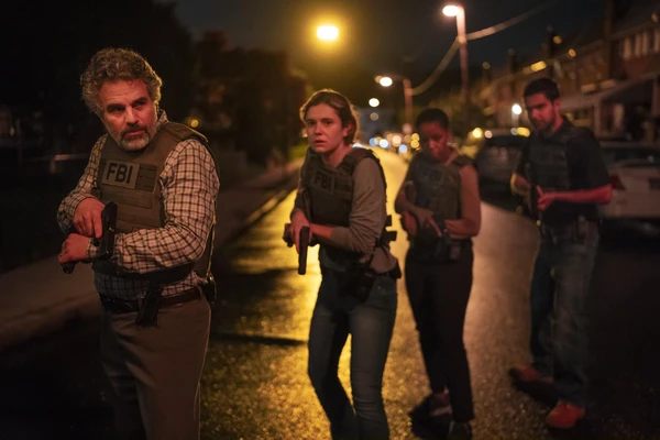 FBI agents, ready for action, walk on a street at night in the series "Task".